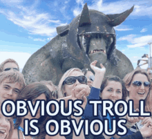 a group of people are posing for a picture with a troll in the background and the caption obvious troll is obvious