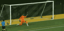 a soccer goalie kicks a ball into the goal