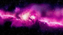 a purple galaxy in the middle of a dark space