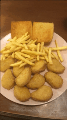 a plate of french fries and chicken nuggets