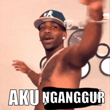 a shirtless man is wearing a hat and a necklace and says aku ngganggur