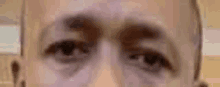 a close up of a man 's eyes with a blurred background .