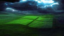 a green field with a windows logo in the foreground