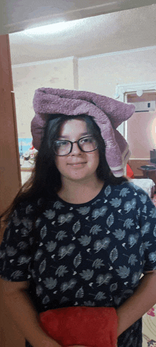 a woman wearing glasses and a towel on her head