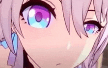 a close up of a anime girl 's eyes with purple and blue irises .