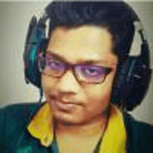 a young man wearing headphones and glasses .