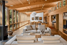 a living room with a couch and a fireplace and lots of windows