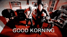 a group of men are playing guitars in a room with the words good korning written on the bottom .