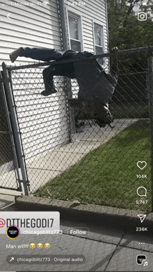 a person is hanging upside down over a chain link fence with a tag that says chicagoblitz773