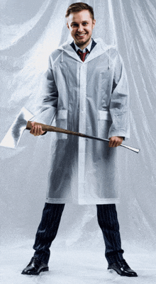 a man in a clear raincoat holding an axe