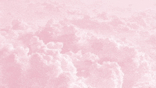 a pink sky with white clouds in it