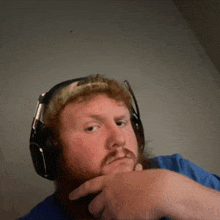 a man with a beard wearing headphones and a hat