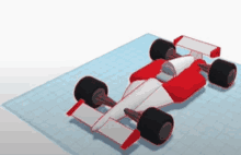 a model of a red and white race car on a blue grid