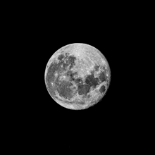 a black and white photo of a full moon against a black background