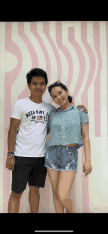 a man and a woman pose for a picture with the man wearing a t-shirt that says h22a 0j09