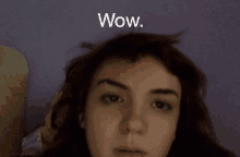 a close up of a girl 's face with the word wow above her