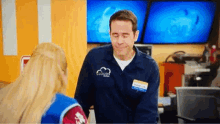 a man wearing a blue shirt that says cloud on it is talking to a woman