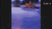 a man is standing in front of a car in a purple and blue video .