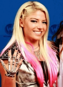 a blonde woman with pink hair is wearing a skeleton hand bracelet on her arm