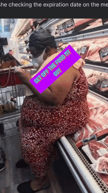 a woman wearing a mask is sitting on a meat display in a grocery store ..