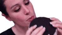 a woman in a black shirt is kissing a black object on a white background