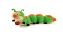 a green and orange stuffed caterpillar is eating a red apple .