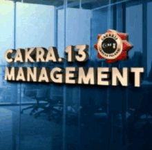 a sign that says cakra 13 management in front of a glass wall