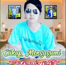 a man wearing sunglasses and a blue shirt with the words cukup mengagumi