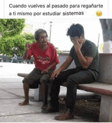 two men are sitting on a bench with one covering his face with his hand