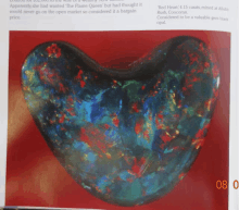 a book is open to a page with a heart shaped opal