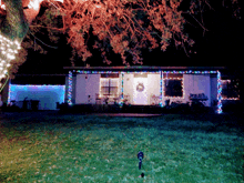 the front of a house decorated with christmas lights