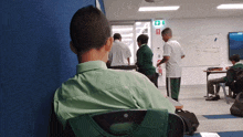 a group of students are sitting in a classroom with a white board that says exit