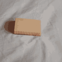 a soap bar is sitting on a white blanket