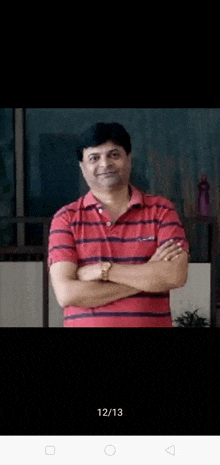 a man in a red striped shirt with his arms crossed