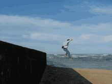 a person is jumping into the ocean while wearing red shoes