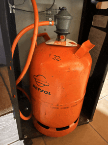 an orange gas cylinder with repsol on it