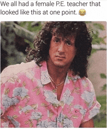 a man with curly hair is wearing a pink shirt