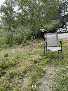 a person standing next to a chair with hi written on the bottom