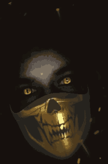 a person wearing a gold mask with a skull on it