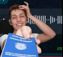 a man is holding up a blue passport that says ' cartina de trabalho ' on it