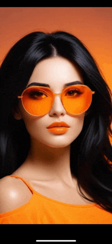 a close up of a woman wearing sunglasses and orange lipstick