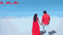 a man in a red shirt and a woman in a red dress holding hands in the desert