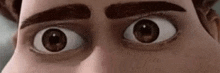 a close up of a cartoon man 's eyes with a surprised look on his face .