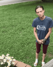 a woman wearing a blue t-shirt that says faith is blind