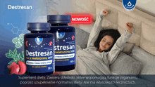 a woman is laying in bed with two bottles of destressan