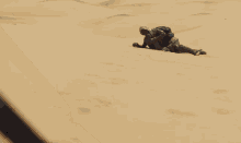 a blurry picture of a person laying on the sand