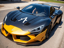 a black and yellow sports car with a letter a on the hood