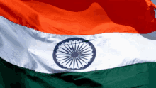 a close up of an indian flag with a blue and white circle in the center