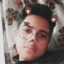 a young man wearing round glasses with bears on them