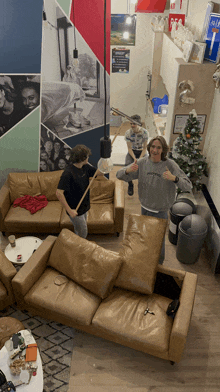 a man wearing a patagonia sweatshirt stands in a living room with other people